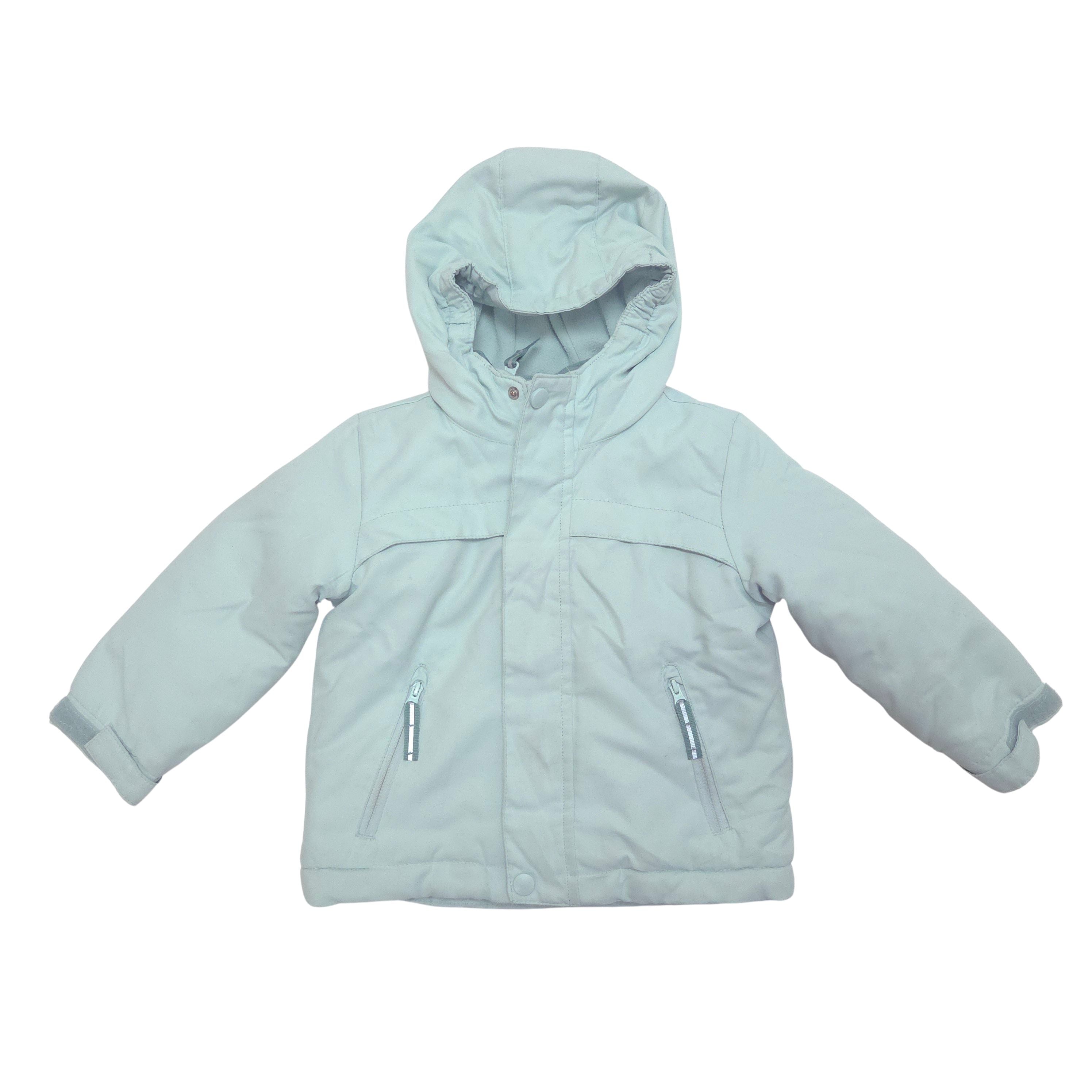 A light blue hooded jacket with zippered pockets, laid flat against a white background.