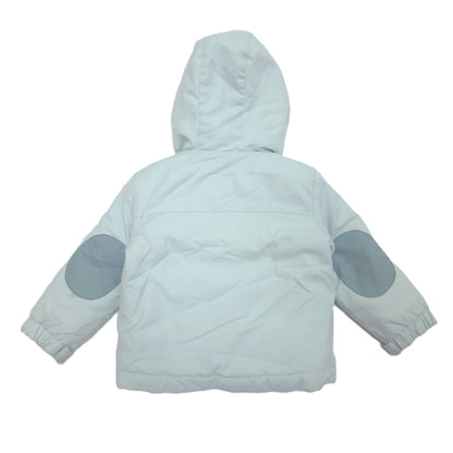A light blue hooded winter jacket shown from the back, featuring light blue elbow patches and elastic cuffs.