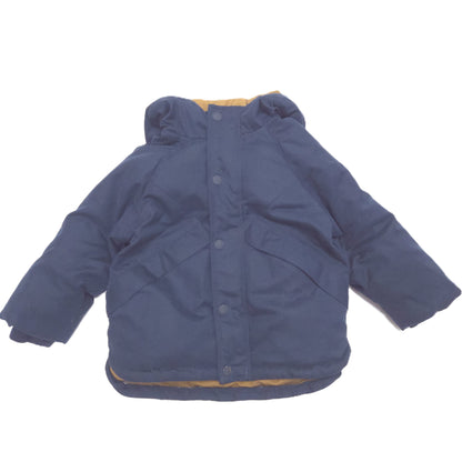 A navy blue hooded puffer jacket with a tan lining, shown flat against a white background.