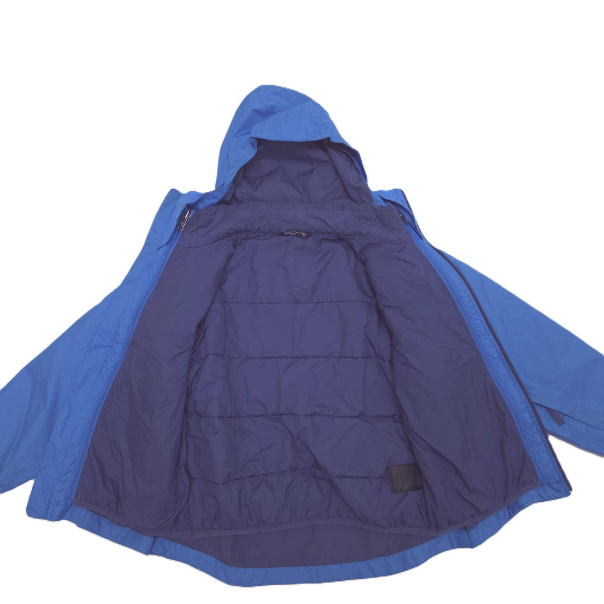 A blue hooded jacket with a dark navy quilted puffer lining, shown open against a plain white background.