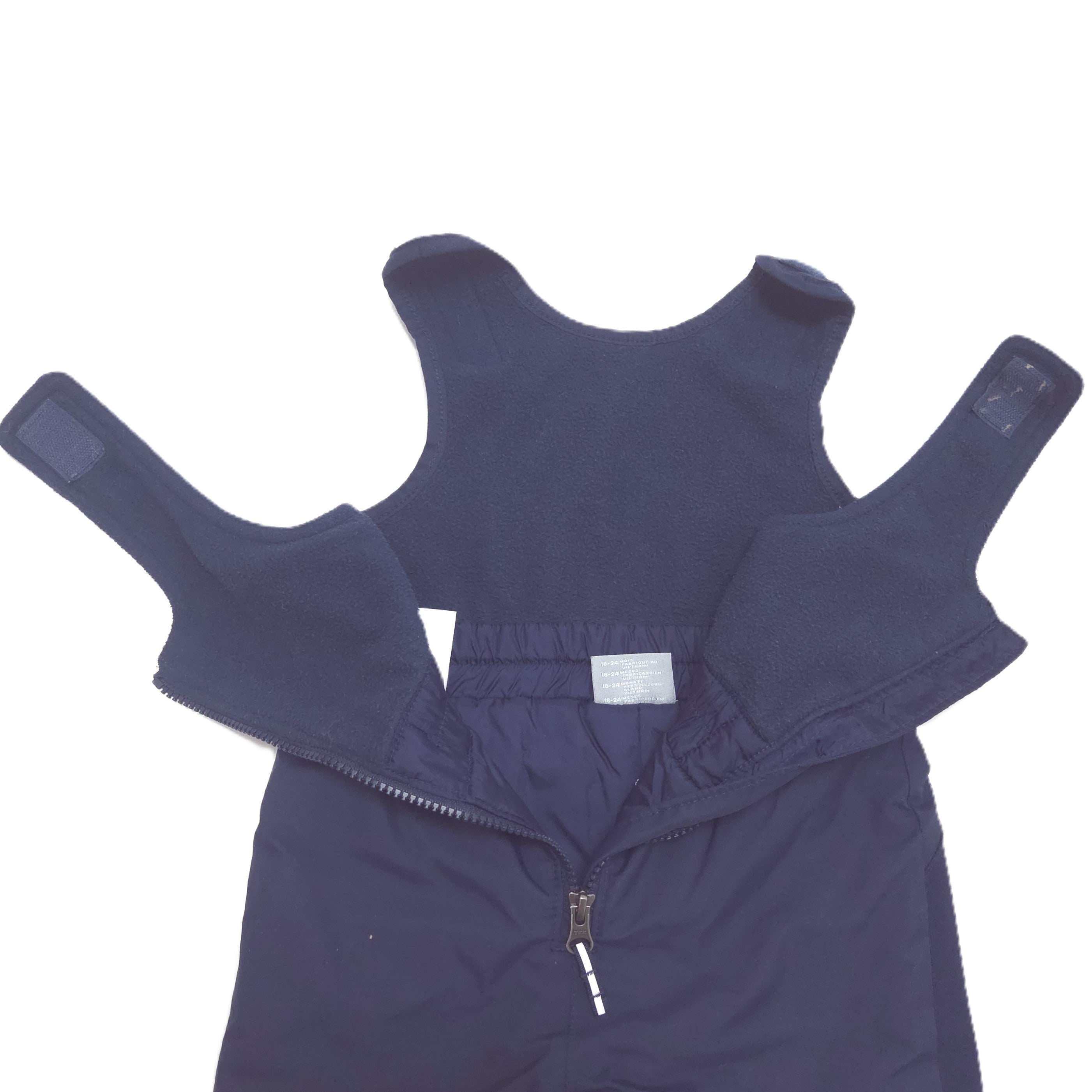 A dark navy blue snow pants laid flat on a white background, showing the front zipper, and shoulder hook-and-loop fastener straps.