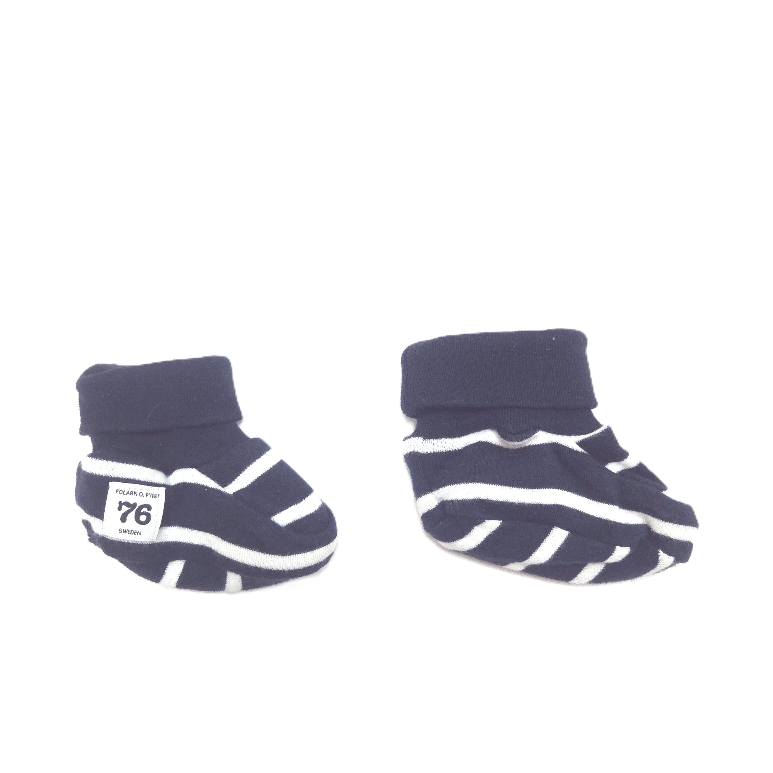 A pair of navy blue and white striped baby booties with ribbed cuffs, displayed on a clean white background.