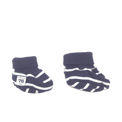 A pair of navy blue and white striped baby booties with ribbed cuffs, displayed on a clean white background.
