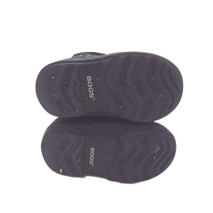 Two black BOGS shoes shown from the sole side, stacked vertically on a white background.