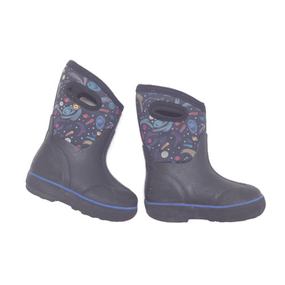 A pair of winter boots in black, featuring a colorful space-themed print on the upper shaft with planets, stars, and rockets.
