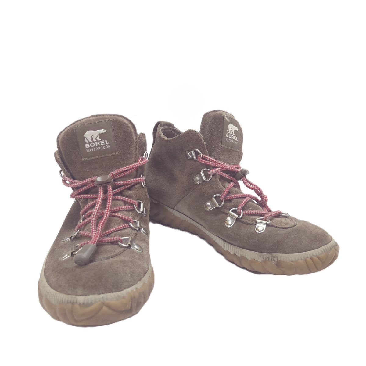 A pair of brown suede boots with red braided laces and silver metal eyelets, shown against a plain white background.