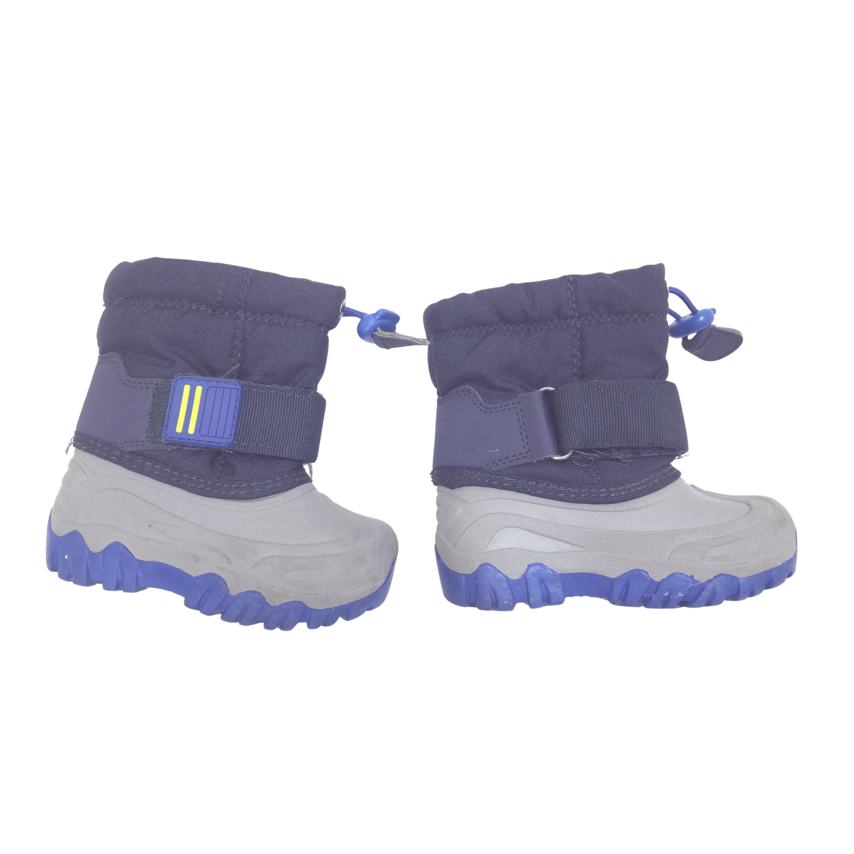 A pair of toddler winter boots in a navy and light gray colorway, featuring a thick blue sole.