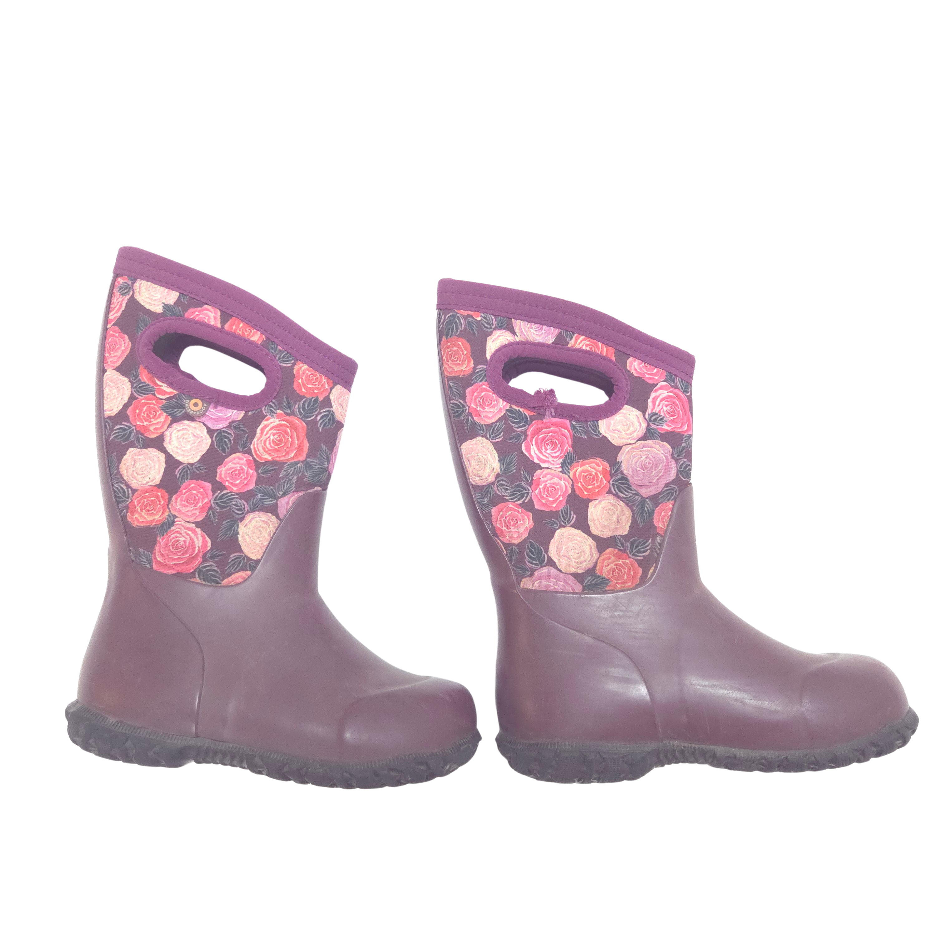 A pair of children's rain boots in a muted plum purple color, featuring a floral print pattern on the upper shaft with pink, red, and peach roses on a dark background.