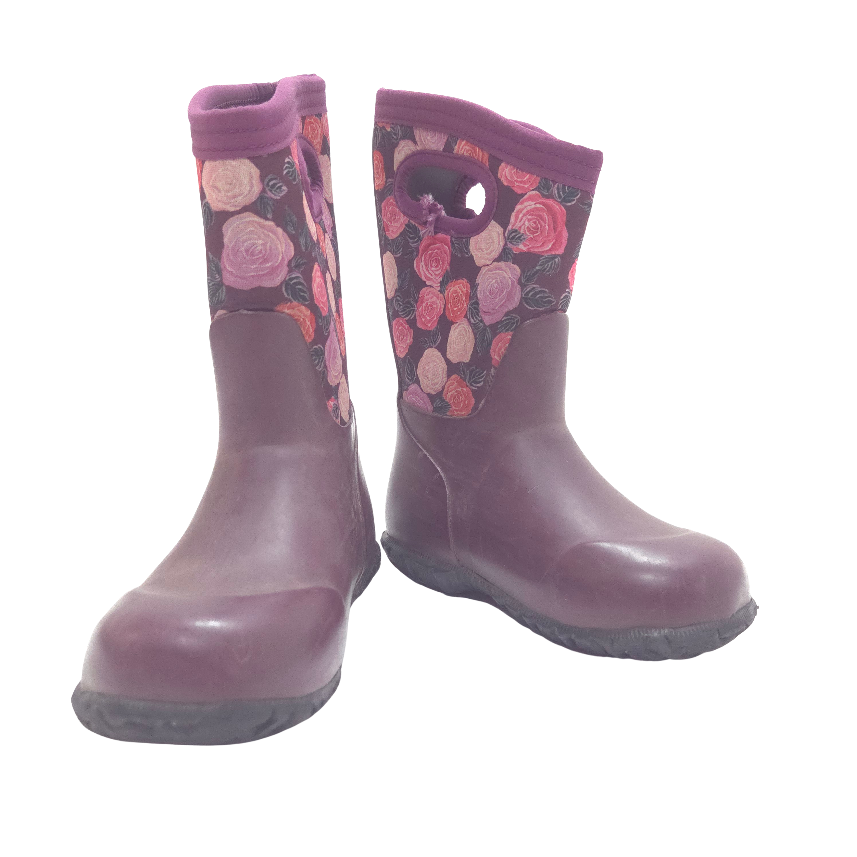 A pair of children's rain boots in a dark plum purple color, featuring a floral pattern on the upper shaft with pink and red roses, set against a plain white background.