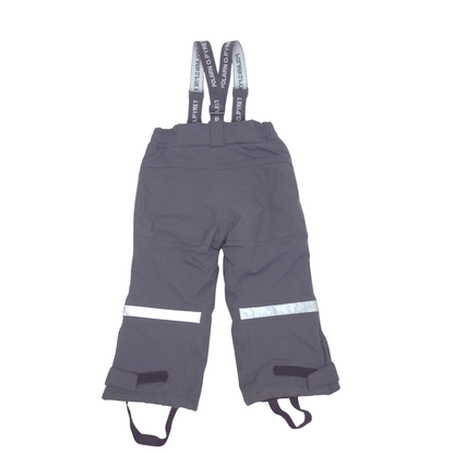 Dark gray snow pants with adjustable suspenders, featuring reflective silver stripes on the lower legs and leg warmers, shown against a plain white background.