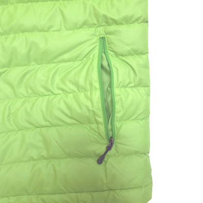 Close-up of a bright lime green puffer jacket showing horizontal quilting and a vertical zippered pocket with a dark zipper pull.