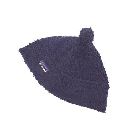 A dark navy blue fuzzy beanie hat with a small bear ears on top and a visible Patagonia logo patch on the side, shown against a plain white background.