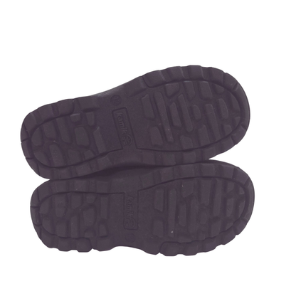 A pair of black winter boots shown from the sole view, displaying their rugged tread patterns on a plain white background.