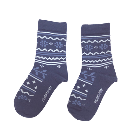 A pair of navy blue crew socks with a white and light blue Nordic/Fair Isle pattern, featuring the text company name printed on the toes.