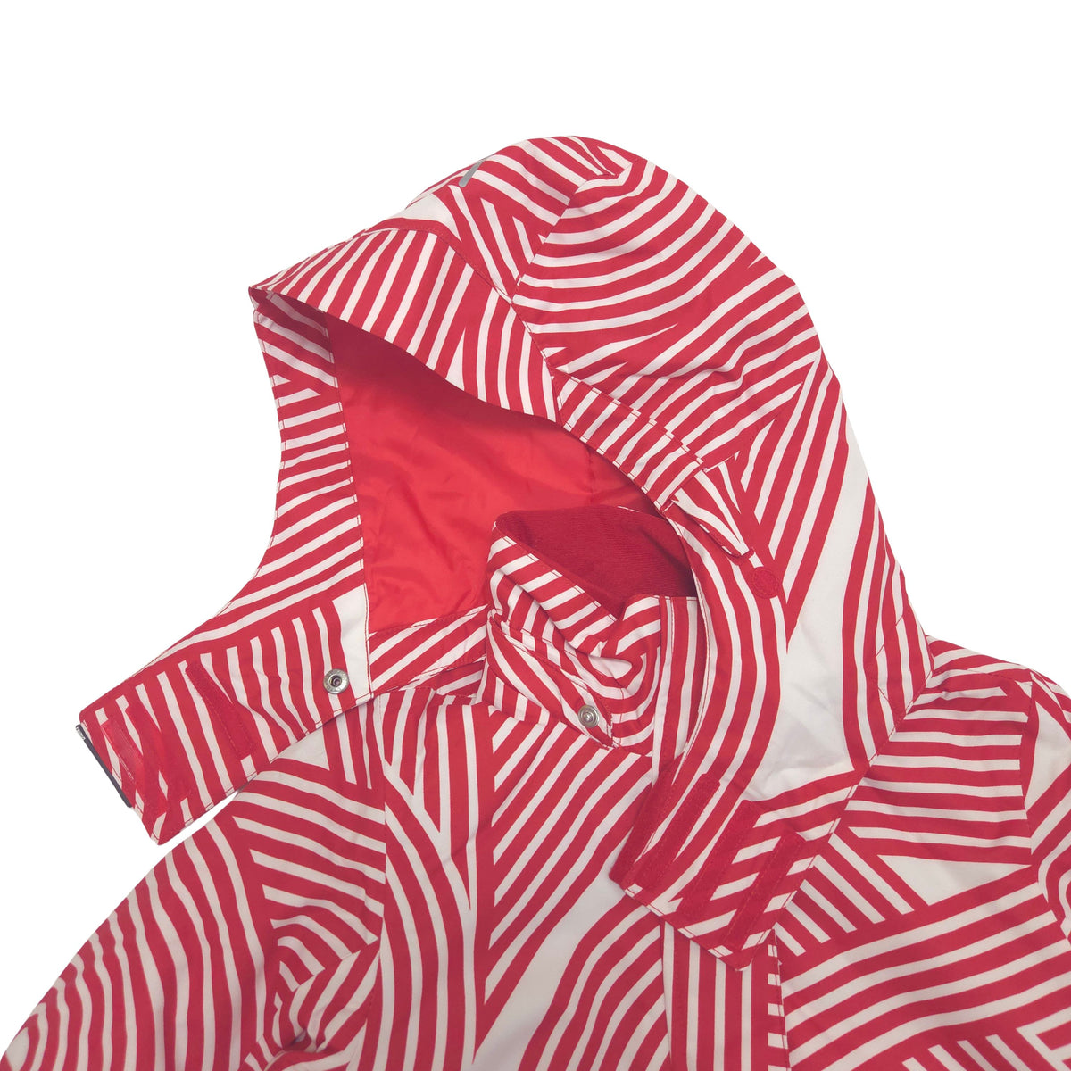 A children's hooded ski jacket featuring a bold red and white wavy stripe pattern hood detail