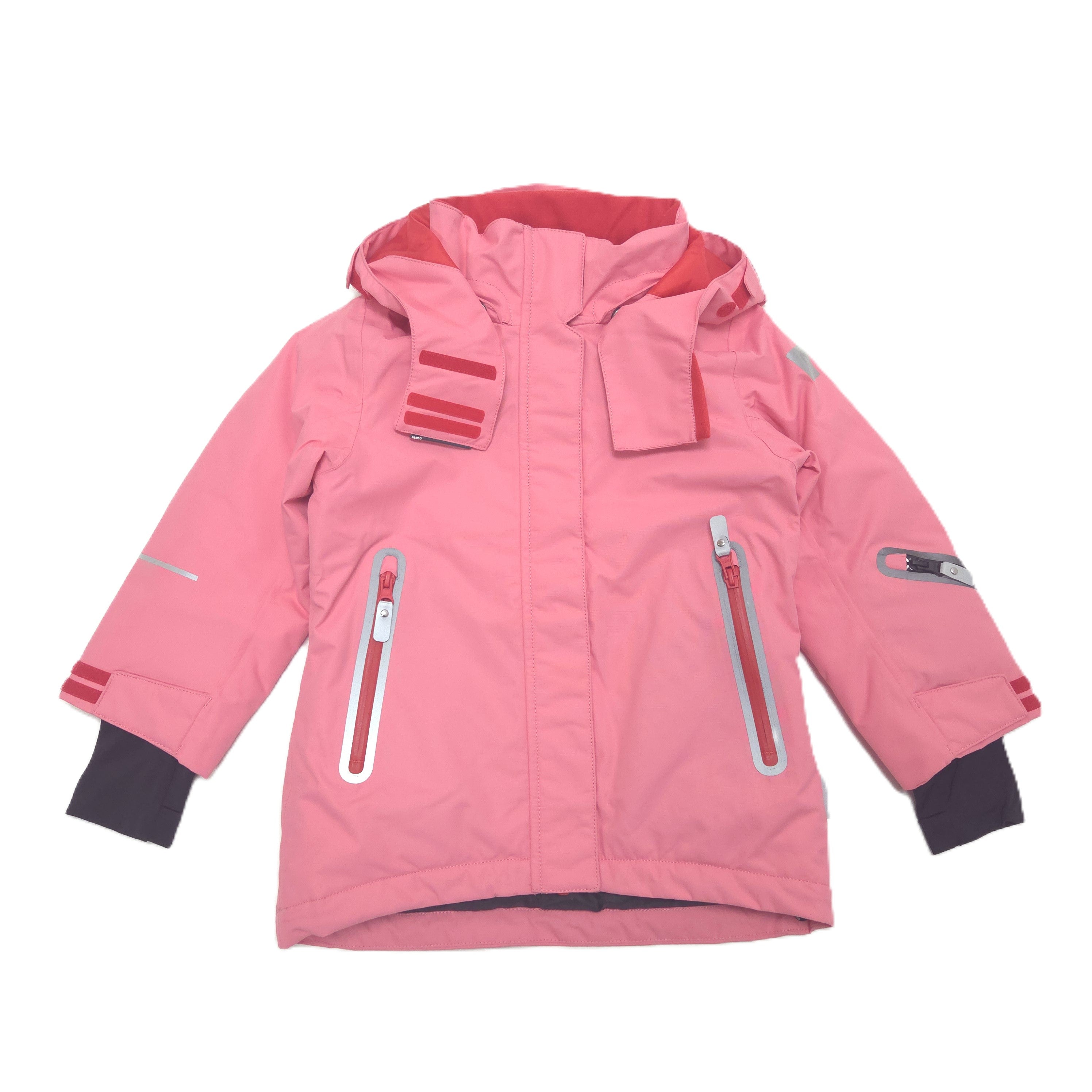 A pink children's hooded snow jacket with multiple zippered pockets, reflective details, and elastic cuffs with thumbholes, shown against a plain white background.