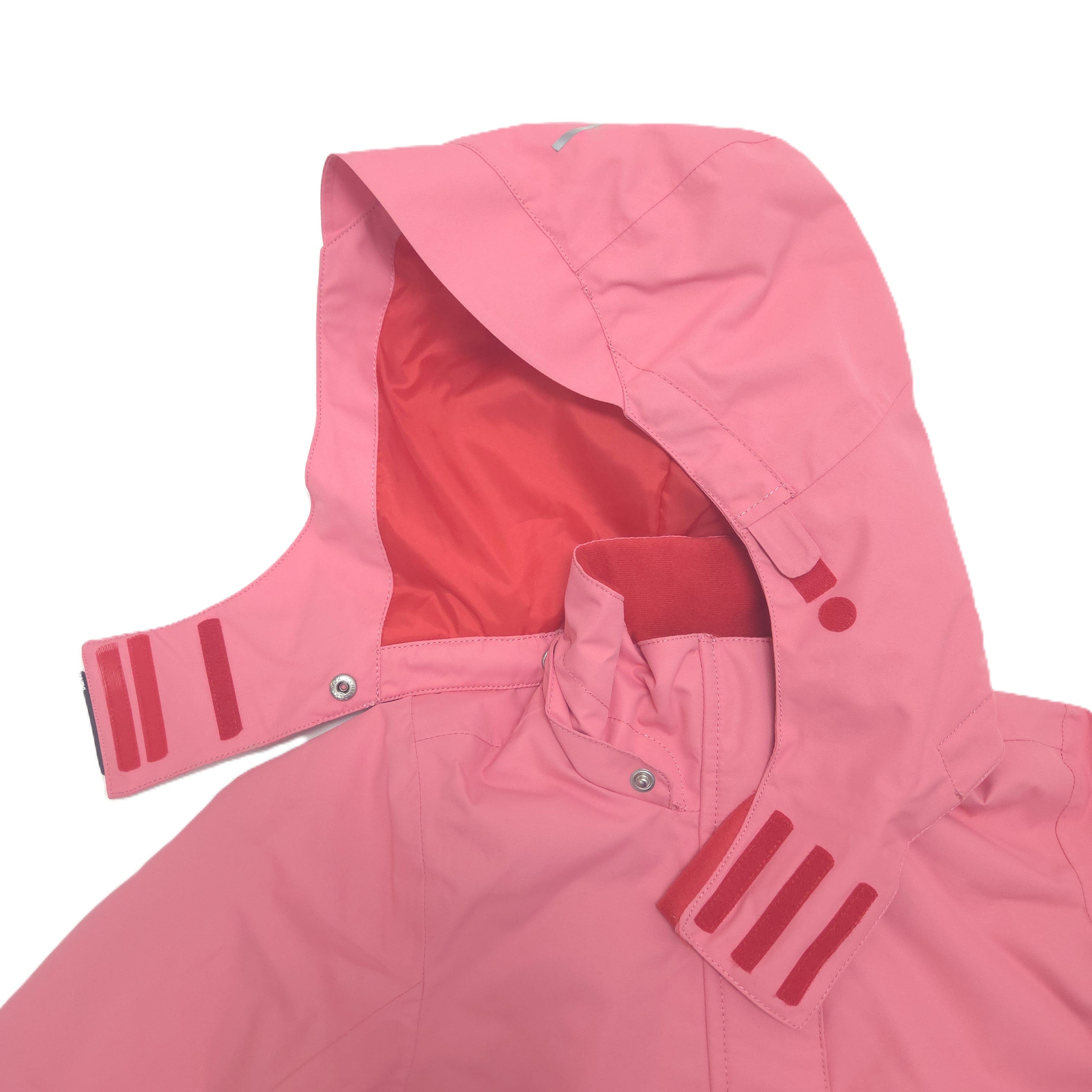A close-up of a pink hooded jacket with a contrasting red inner hood lining, shown on a plain white background.