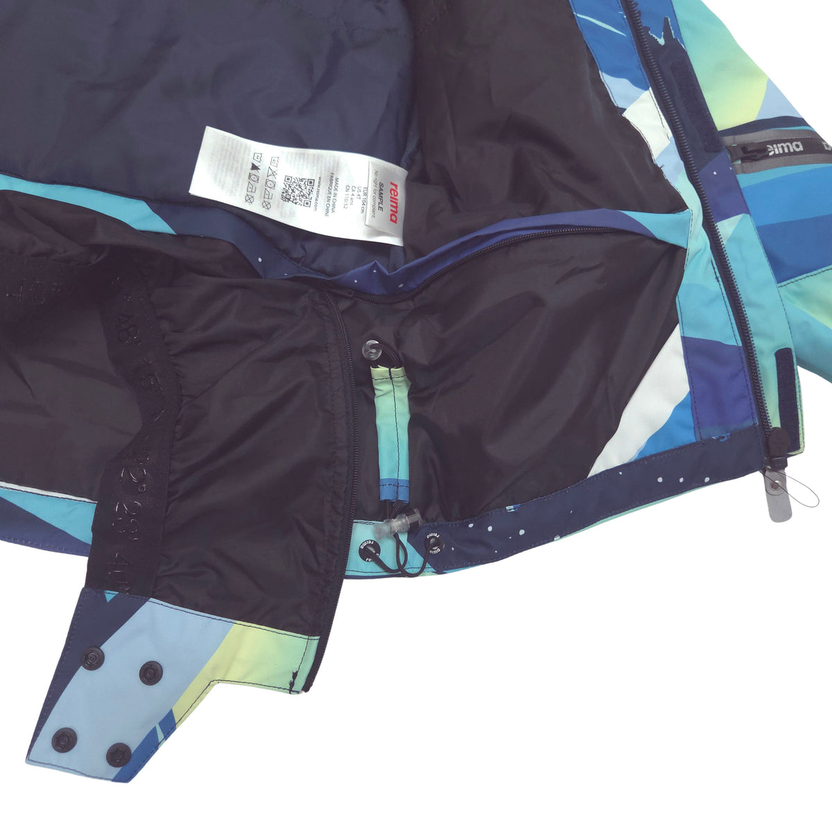 Close-up of a ski jacket showing the removable powderskirt