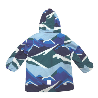 A hooded jacket shown from the back, featuring a geometric mountain pattern in shades of blue, teal, navy, and white.