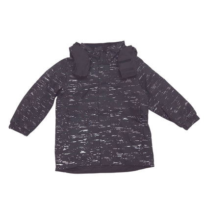 A hooded long-sleeve jacket with a dark charcoal and white heathered reflective pattern, shown flat against a solid white background.