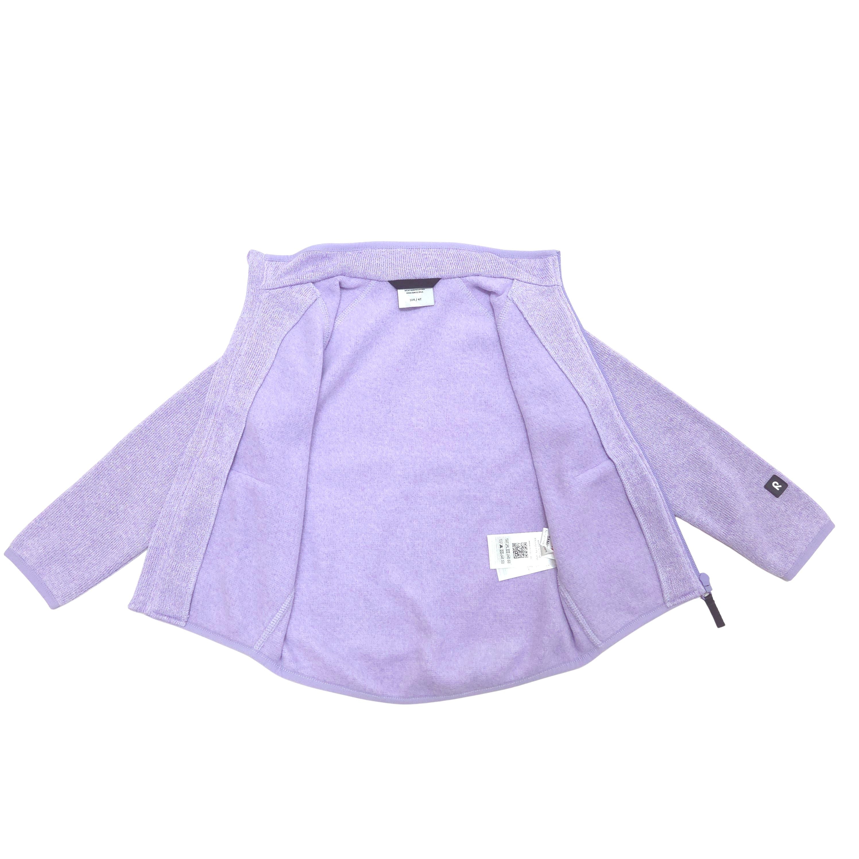 A light purple/lavender zip-up fleece jacket shown flat against a white background, with a visible interior label and a small black logo patch on the cuff.