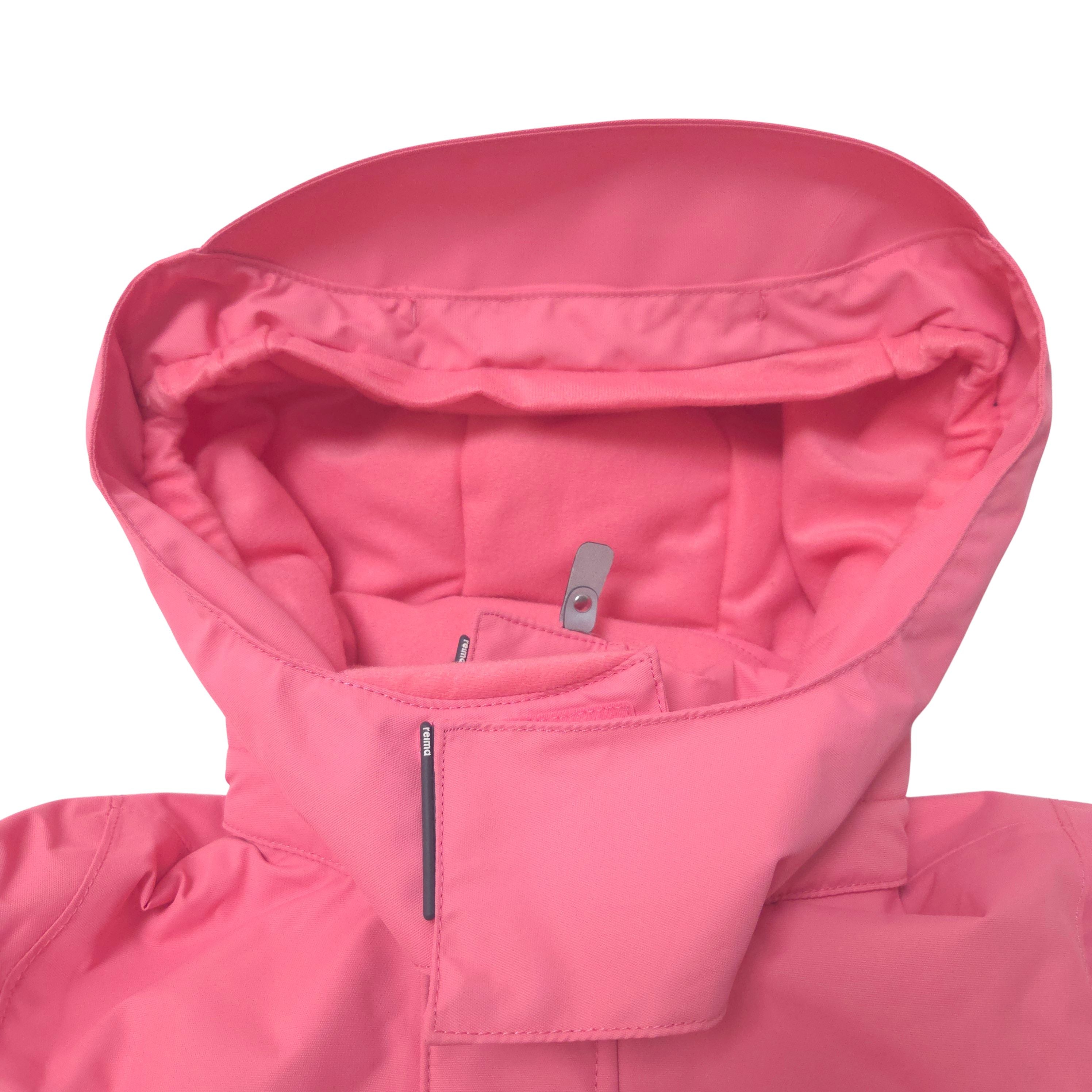 Close-up of a pink hooded jacket showing the inner hood lining, zipper details, and fabric texture against a white background.