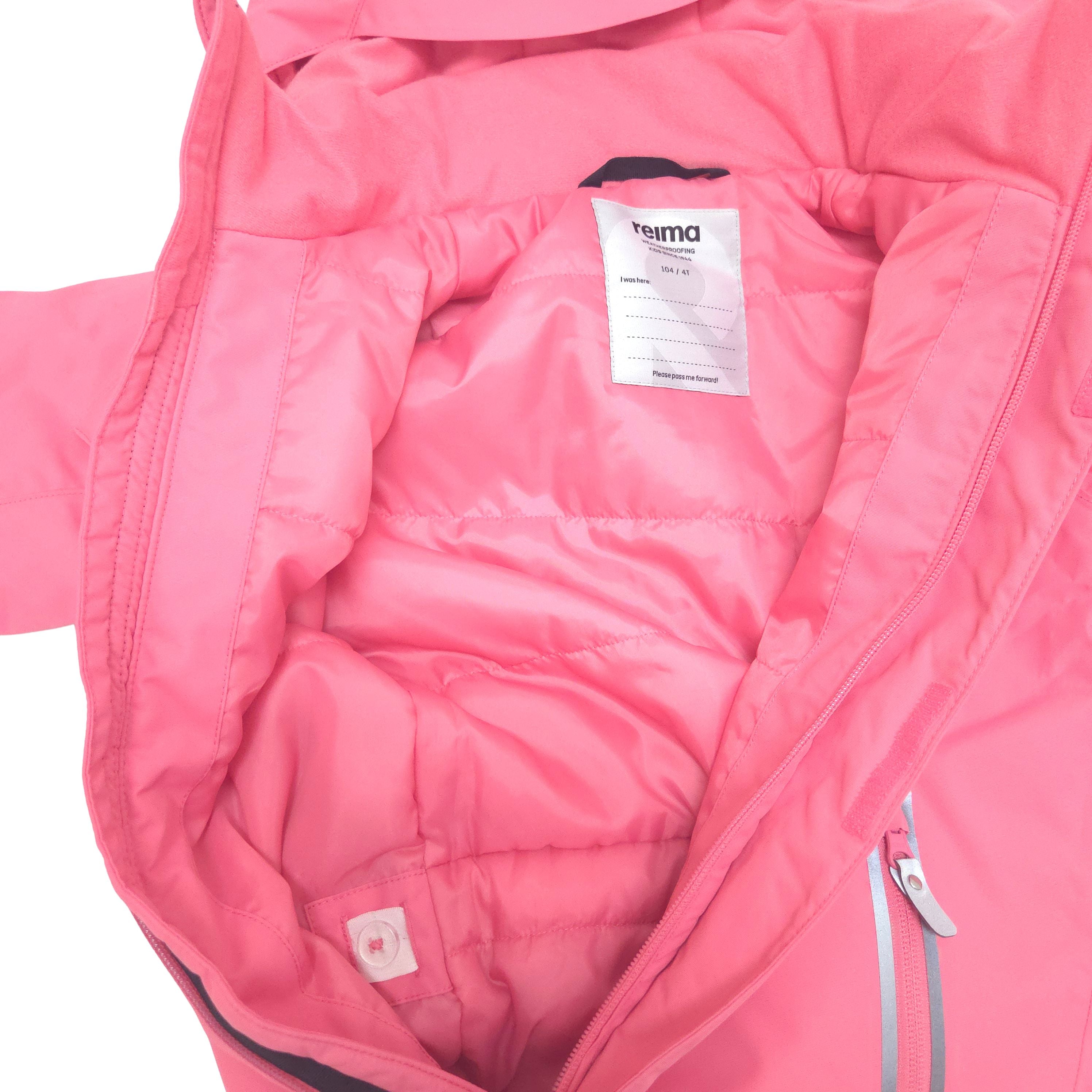 Close-up of the interior of a bright pink snowsuit, showing the quilted lining, zipper hand pocket and Integrated waist adjuster with buttons make it easy to fine-tune the fit