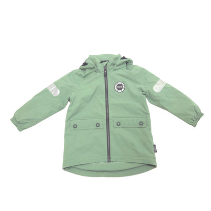 A sage green hooded jacket, featuring a front zipper, two buttoned flap pockets, reflective white patches on the sleeves, and a circular logo patch on the left chest, displayed on a solid white background.