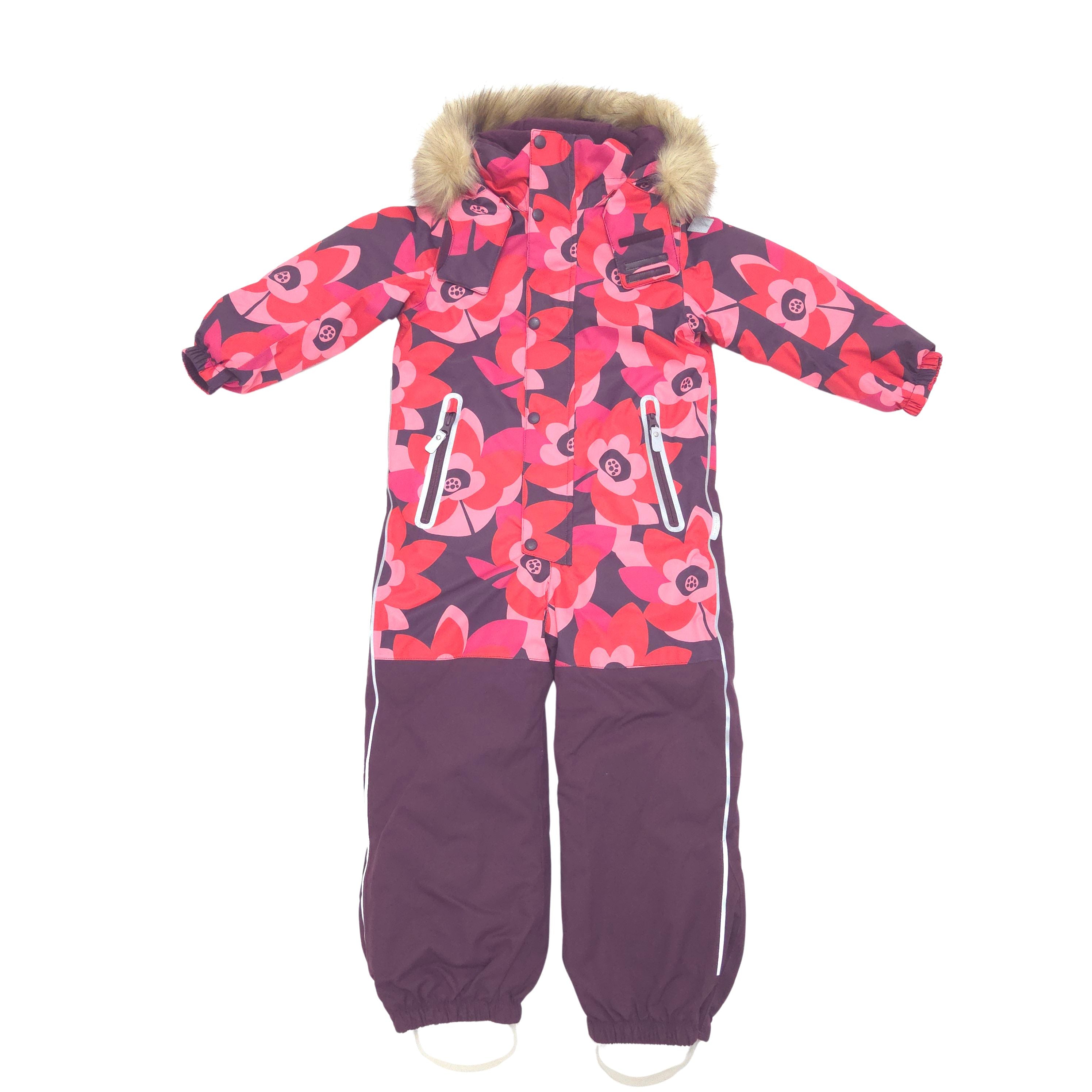 A children's one-piece snowsuit with a pink and red floral pattern on the upper body and sleeves, solid dark purple pants, a faux-fur trimmed hood, and white zipper accents.