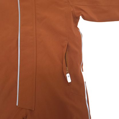 Close-up of a brown snowsuit showing a side zip pocket with a white zipper pull and thin white piping details on a white background.