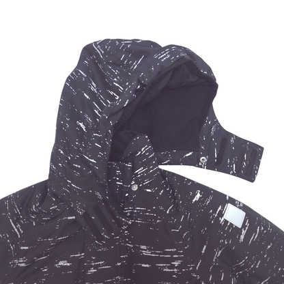 Close-up of a hooded jacket in a very dark charcoal or black color with an all-over white abstract brushstroke or splatter pattern, shown on a plain white background.