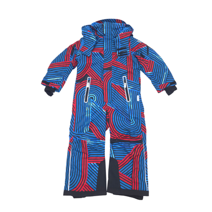 A hooded one-piece snowsuit with a bold abstract geometric pattern in blue and red, featuring multiple zippered pockets and black trim.