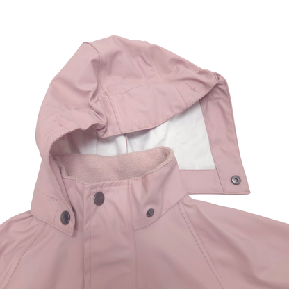 Close-up of a dusty pink hooded rain jacket with a white inner lining and dark snap buttons, shown on a plain white background.