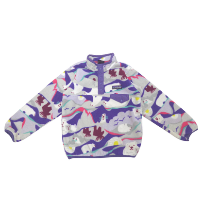 A children's Patagonia fleece pullover with a purple stand collar and a colorful all-over print of polar bears, penguins, and mountains on a light gray background.