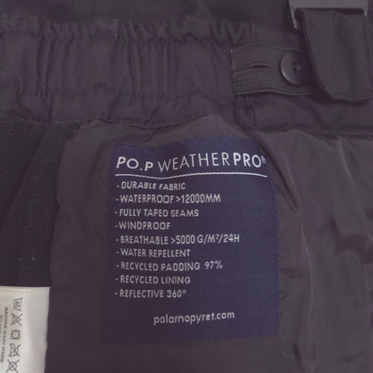 Close-up of the inside waistband of black waterproof pants, Integrated waist adjuster with buttons make it easy to fine-tune the fit.