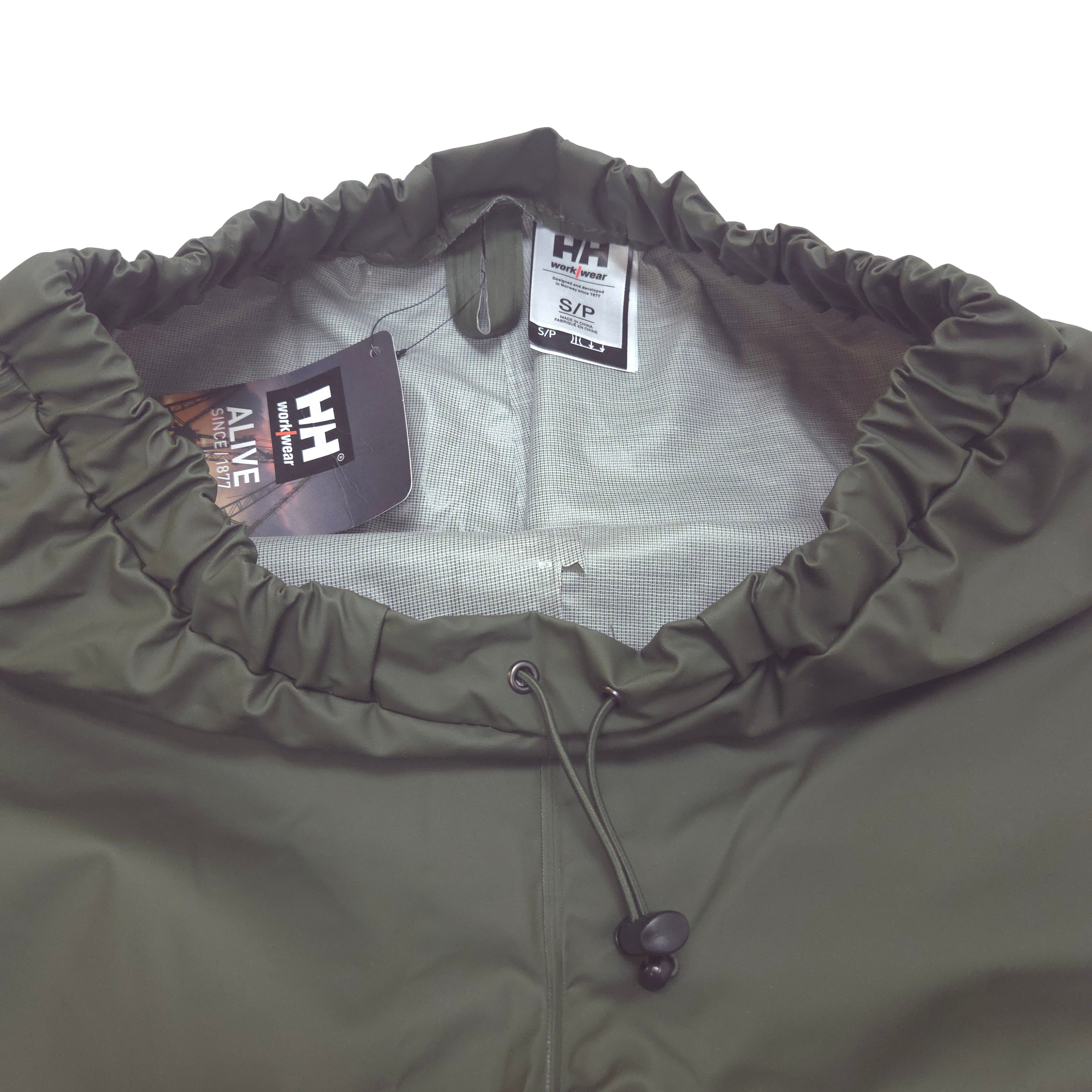 Close-up of the inside green rain pants, showing the gathered elastic and  drawstring on waist