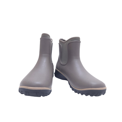 A pair of brown grubber rain boots with elastic side gore panels, shown on a plain white background.