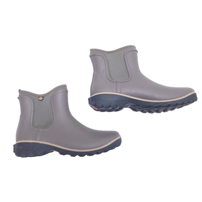 A pair of brown rubber rain boots with elastic side panels and dark grey soles, shown from the side on a plain white background.