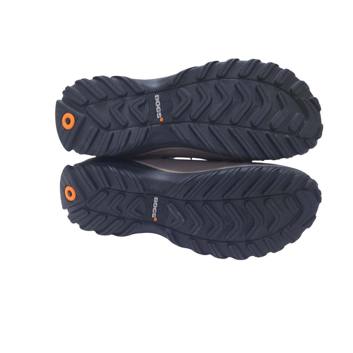 Top-down view of a pair of rugged black Bogs rain boots showing the textured outsoles, with small orange accents and the Bogs logo visible.