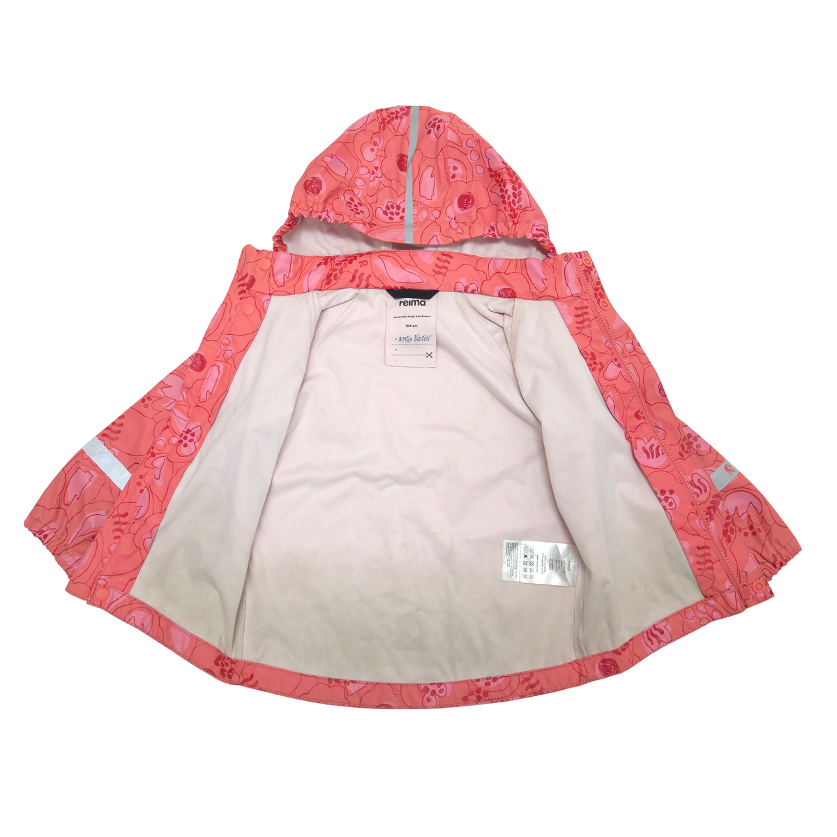 A children's hooded raincoat shown open against a plain white background. The outer shell is coral pink with a darker pink floral pattern and reflective silver trim.