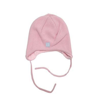 A light pink knit beanie hat with ear flaps and long tie strings, featuring a small square brand patch on the front, shown against a plain white background.