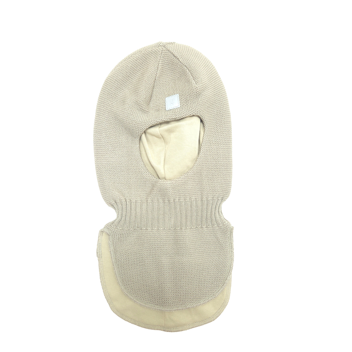 A light beige knit balaclava mask with a matching neck gaiter, featuring a small white square label on the forehead, shown against a plain white background.