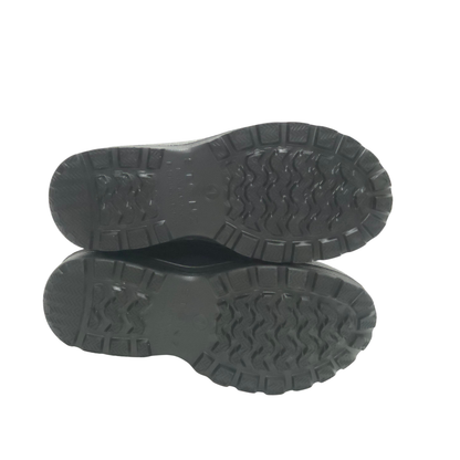 A pair of black rubber boots shown from the bottom, displaying their textured tread patterns against a plain white background.