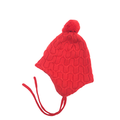 A bright red knit pom-pom beanie hat with ear flaps and long red chin ties, shown on a plain white background.
