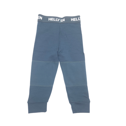 A pair of children's knit pants in a dusty slate blue green color, featuring a contrasting dark gray elastic waistband with 'HELLY HANSEN' printed in white. The pants have a straight leg, ribbed ankle cuffs, and a central seam detail near the upper thigh. Fleece knee patches