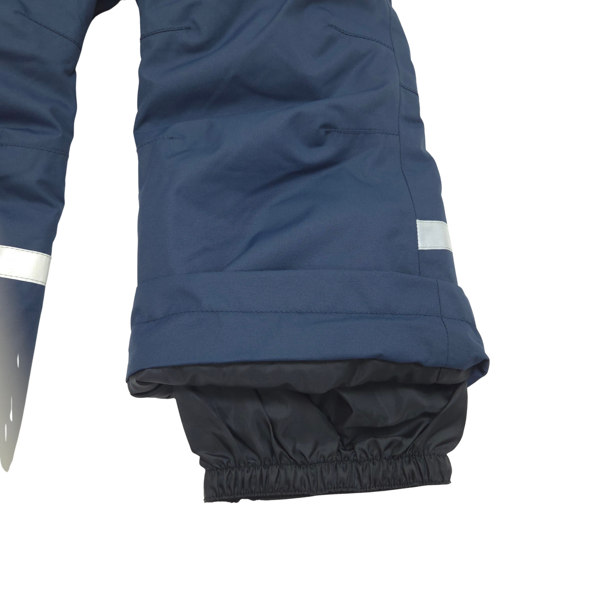 Internal gaiters at cuffs keep out snow; external scuff guards protect from boot- and ski-edge wear
