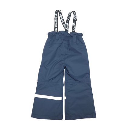 A pair of navy blue snow pants with adjustable black suspenders featuring white text, and a white reflective stripe near the lower left leg, shown against a plain white background.