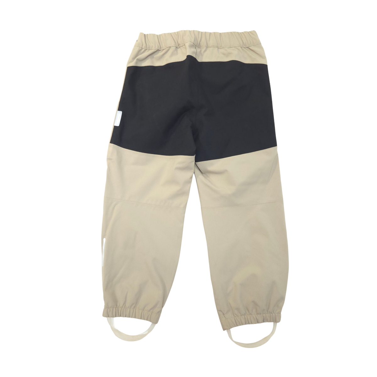 Colorblock pants in beige and black, featuring an elastic waistband and adjustable elastic ankle cuffs.