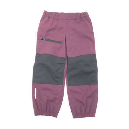 A pair of color-blocked children's pants in dusty red and black, featuring an elastic waistband, zippered side pocket, and elastic cuffs.