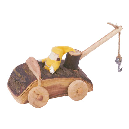 A handcrafted wooden toy car with a bark-textured brown body, natural wood wheels, a light wood handle, and a small yellow plush figure on top, photographed on a white background.